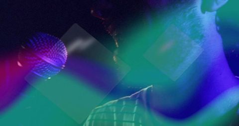 Energetic Singer Performing in Neon Lit Nightclub