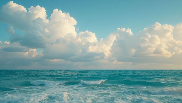 Tranquil Ocean with Gentle Waves and Fluffy White Clouds