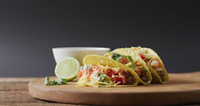 Image of freshly prepared tacos and bowl with sauce lying on board on grey background - Download Free Stock Photos Pikwizard.com