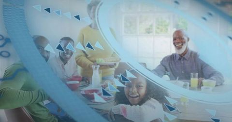 Multigeneration black family sharing sunny breakfast as woman in yellow serves red bowls