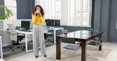 Confident Businesswoman Enjoying Coffee in Modern Office