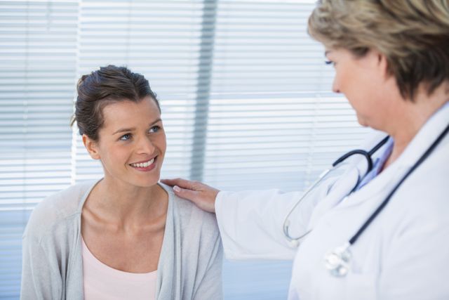 Doctor Comforting Smiling Patient in Hospital - Download Free Stock Photos Pikwizard.com