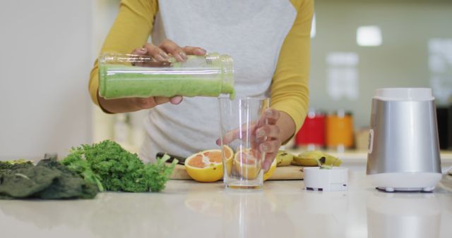 Woman Preparing Green Smoothie in Modern Kitchen - Download Free Stock Images Pikwizard.com