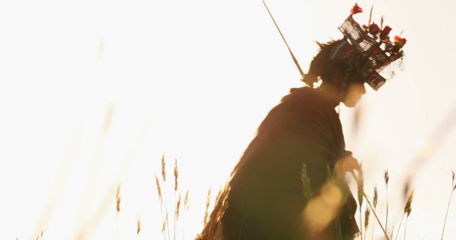 Person Silhouetted in Ethereal Light Wearing Traditional Headgear with Flowers - Download Free Stock Images Pikwizard.com