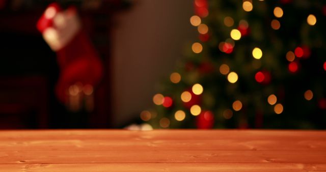 Festive scene featuring a wooden table with a blurry background of Christmas lights from a decorated tree. Ideal for holiday-themed projects like greeting cards, banners, social media posts, ads, and seasonal promotional content.