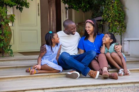 Happy Family Enjoying Moment Together on Front Porch