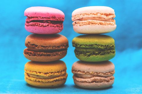 Colorful French Macarons on Blue Background