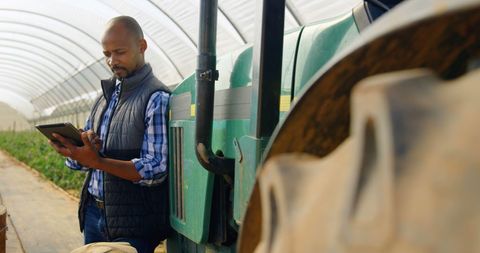 Middle-Aged Farmer Using Tablet in Greenhouse for Modern Farming - Download Free Stock Images Pikwizard.com