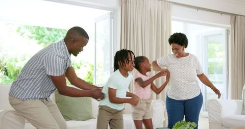 Happy Family Dancing Together in a Bright Living Room