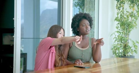 Friends Chatting and Enjoying View on Hotel Balcony