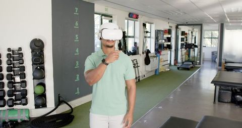 Man Engaging in Virtual Therapy with VR Headset in Rehab Center