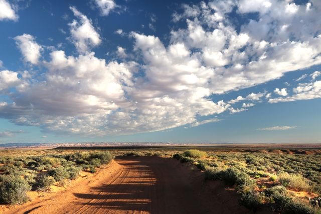 Dirt Road and Expansive Sky in a Vast Desert Landscape - Download Free Stock Photos Pikwizard.com