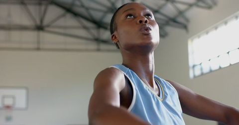 Focused african american female basketball player looking to shoot