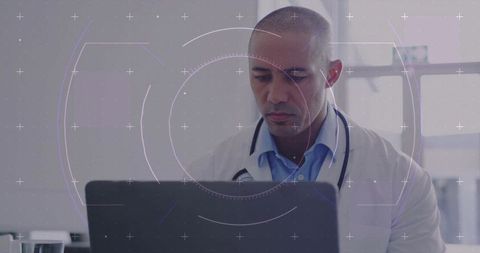 Doctor Analyzing Medical Data on Laptop in Modern Clinic Office