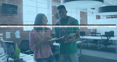 Coworkers Discussing Project in Modern Open Office