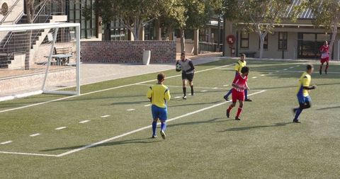 Teen soccer player developing goalkeeping skills on school field