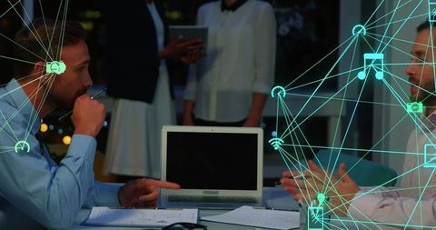 Digital Connectivity in Night Office Meeting