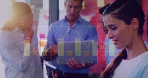 Focused Business Team Analyzing Financial Graphs on Devices