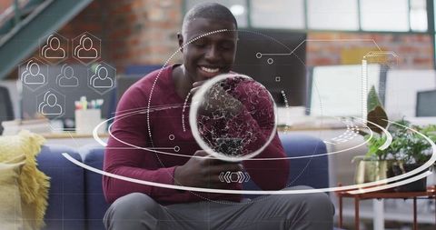 Businessman Engaging with Holographic Globe in Modern Office Environment