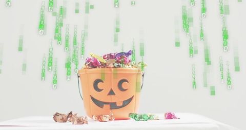 Halloween candy bucket overflowing with wrapped sweets and green binary matrix overlay