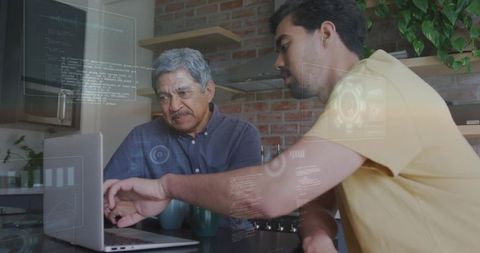 Senior learning coding at home while younger mentor guiding on laptop with hud overlays