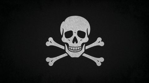 Pirate ship white skull and crossbones graphic on dark background