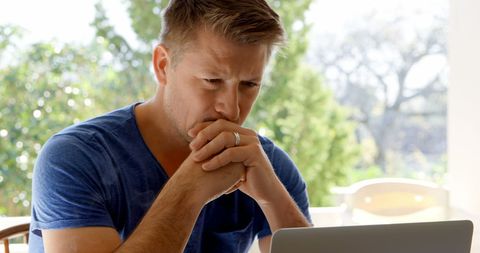 Concerned Middle-Aged Man Intently Reading at Laptop - Download Free Stock Images Pikwizard.com