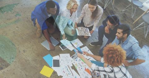 Diverse team collaborating on creative project with tech integration