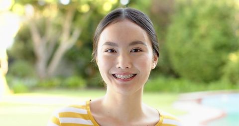 Cheerful Adult Asian Woman Smiling in Backyard