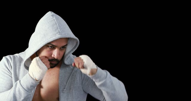 Focused Boxer Training in Hoodie with Hands Wrapped - Download Free Stock Images Pikwizard.com
