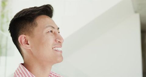 Smiling Young Man Looking Away in Bright Modern Home - Download Free Stock Images Pikwizard.com
