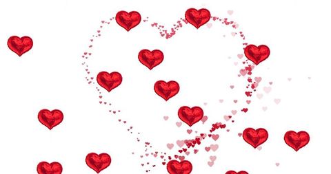 Red foil heart balloons forming floating heart shape with pink confetti on white