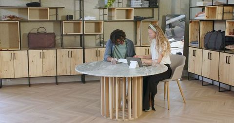 Diverse Colleagues Collaborating at Modern Office Table on Project