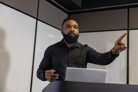 Professional speaker engaging presentation in modern conference room