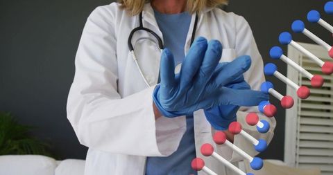 Clinician putting on blue gloves with stethoscope and dna helix overlay for genetics care