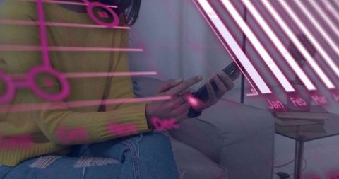 Woman tapping smartphone on sofa with neon-pink data overlay and monthly chart