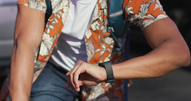 Man Checking Smartwatch Outdoors in Casual Summer Outfit - Download Free Stock Images Pikwizard.com