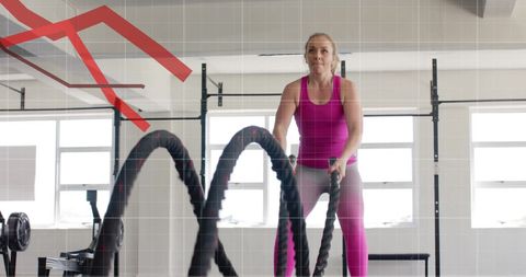 Determined Woman Exercising with Battle Ropes in Modern Gym - Download Free Stock Images Pikwizard.com