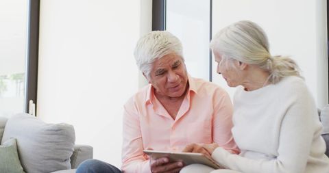 Senior Couple Engaging with Technology on Tablet at Home - Download Free Stock Images Pikwizard.com