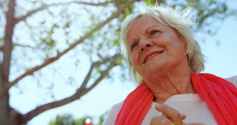 Senior Woman Smiling While Practicing Yoga Outdoors