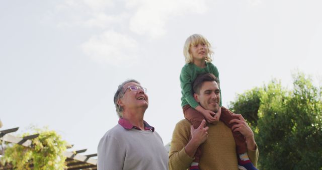 Three Generations of Family Bonding Outdoors on Sunny Day - Download Free Stock Images Pikwizard.com