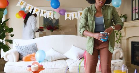 Family Tidying Up After Birthday Party Celebration at Home