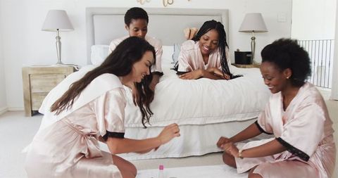 Women Enjoying Pampering Manicure Session at Home in Silk Robes