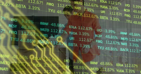Coworkers Analyzing Data with Digital Stock Market Display