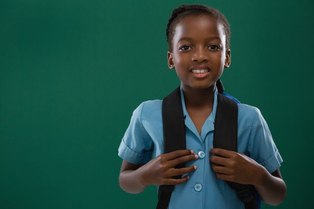 School girl with backpack standing against chalk board - Download Free Stock Photos Pikwizard.com