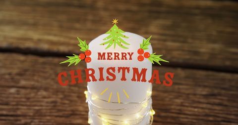 Merry Christmas Text Over Decorative Candle Light