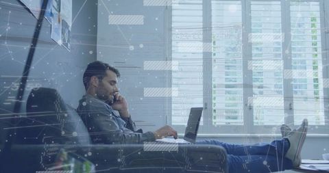 Remote professional reclining on sofa using laptop and phone in bright modern home office