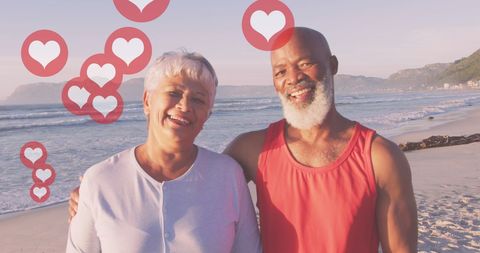 Senior Couple Enjoying Romantic Beachtime with Heart Graphics