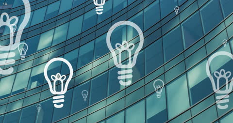 Digital Technology and Innovation Symbolized by Lightbulbs on Glass Building