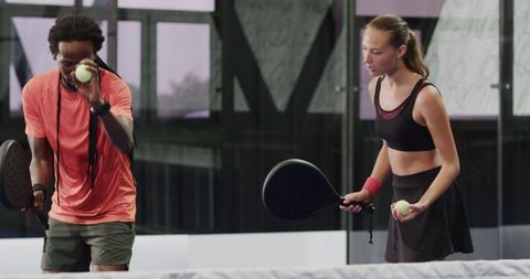 Focused athletes playing padel in modern indoor court